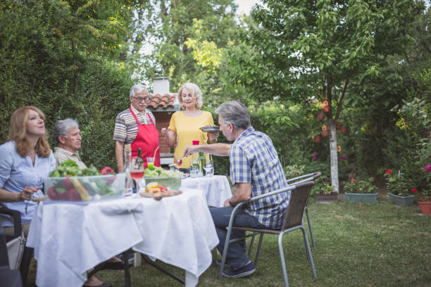 istock Senior people, friends, enjoying backyard barbecue 966830486