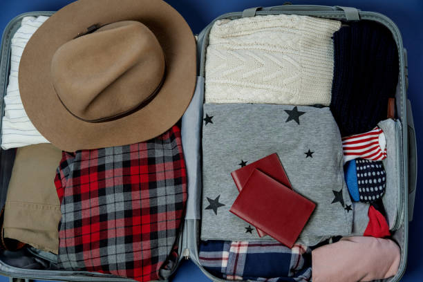 istock Open suitcase packed for travelling. Winter vacations and holidays. Top view 966834876