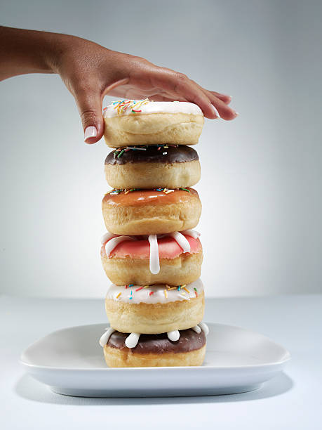 istock Woman picking donut from plate 96684395