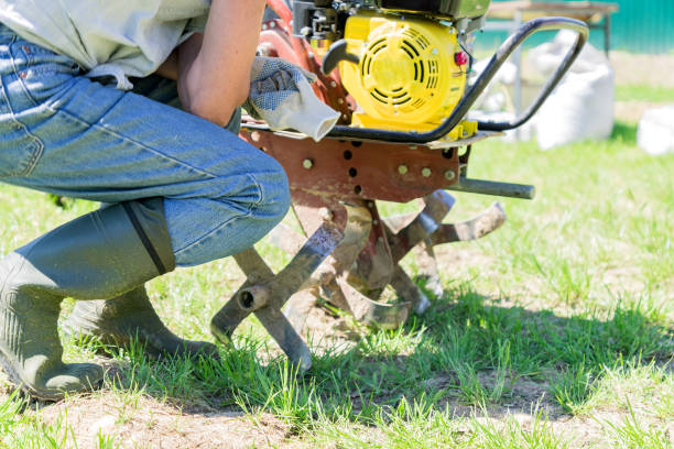 istock man in rubber boots starts a tractor (motoblock)  for plowing fields 966845232