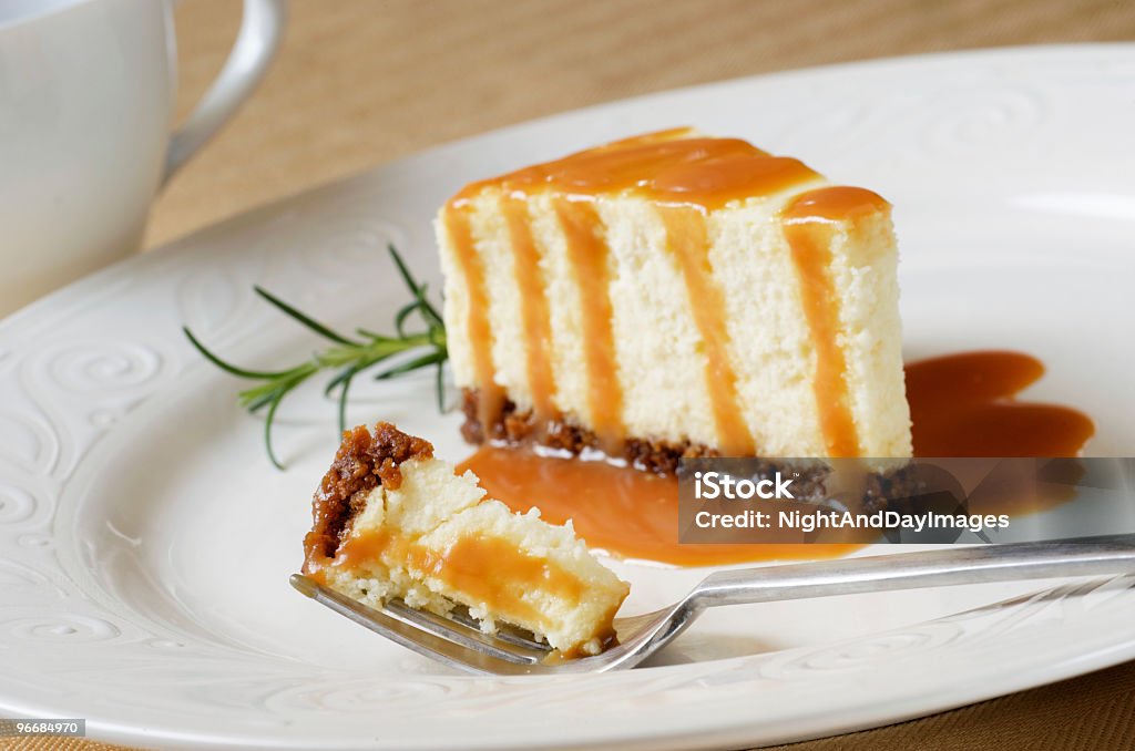 Cheesecake Slice with Caramel Sauce, Bite on Fork  Baked Stock Photo