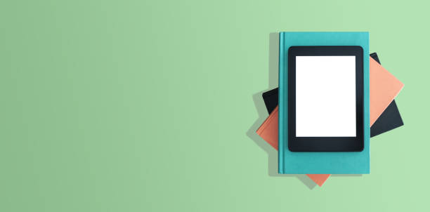 istock top view of e-book reader on stack of books on green desktop 966850000