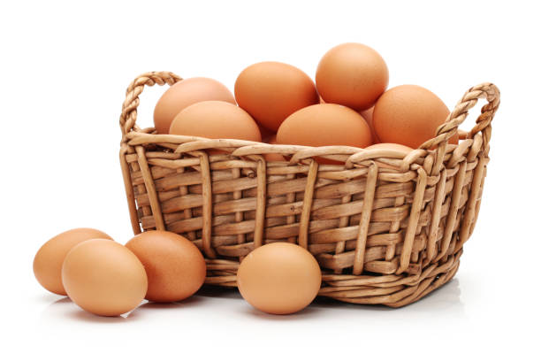 istock Basket with eggs in front of white background 966854280