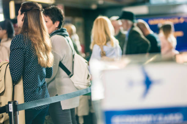 istock People waiting in line at an airport 966855652