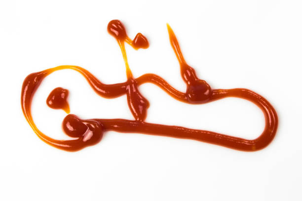 istock Tomato sauce isolated on white background. Red ketchup splashes isolated on white background, top view 966856246
