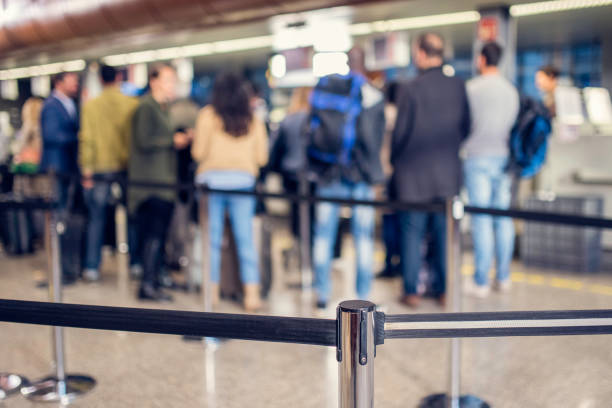istock Group of unrecognizable people waiting at airport check-in 966856650