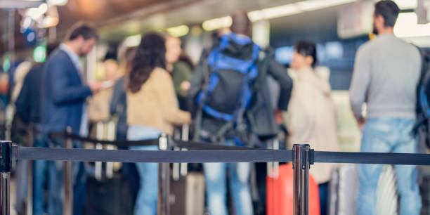 istock Group of unrecognizable people waiting at airport check-in 966863398