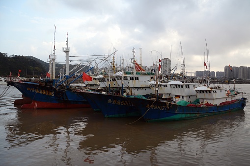 Colourful fishing boats moored at Shenjiamen Fishing Port, the traditional center of Zhoushan Fishery and the largest fishing port of China. Zhejiang province, China