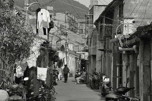 People along an alley in Shenjiamen Fishing village, the traditional center of Zhoushan Fishery and the largest fishing port of China. Zhejiang province, China