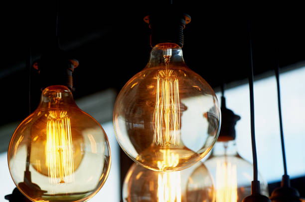 istock Edison light bulb hanging on a long wire. Cozy warm yellow light.Retro 966870940