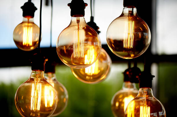 istock Edison light bulb hanging on a long wire. Cozy warm yellow light.Retro 966873362