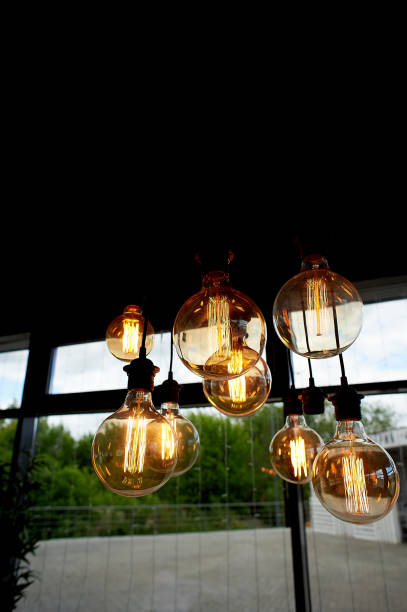 istock Edison light bulb hanging on a long wire. Cozy warm yellow light.Retro 966873412