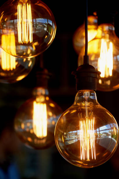 istock Edison light bulb hanging on a long wire. Cozy warm yellow light.Retro 966873692