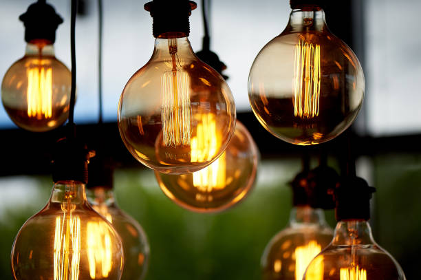 istock Edison light bulb hanging on a long wire. Cozy warm yellow light.Retro 966873826