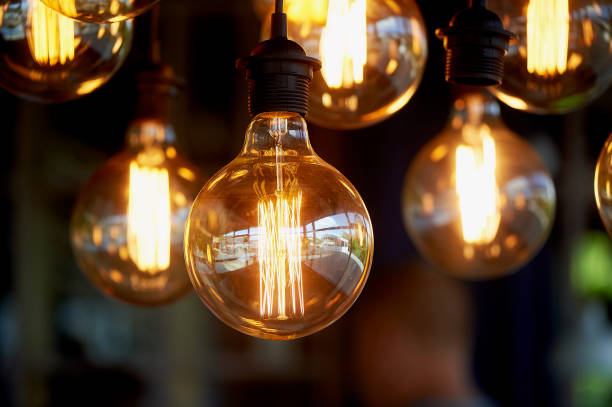 istock Edison light bulb hanging on a long wire. Cozy warm yellow light.Retro 966873968