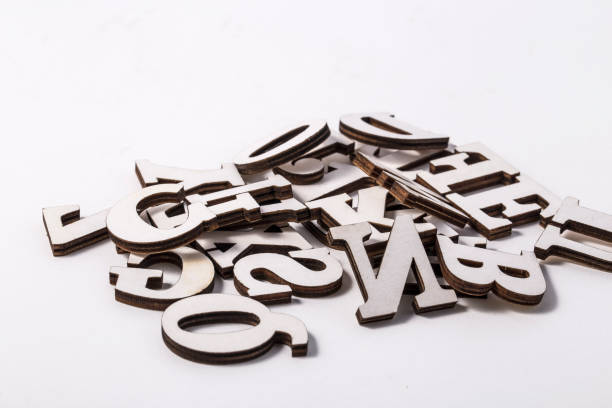 istock Alphabet letters on wooden scrabble pieces, isolated on white. 966878372