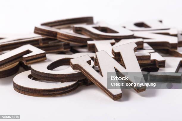 Alphabet Letters On Wooden Scrabble Pieces Isolated On White Stock Photo - Download Image Now