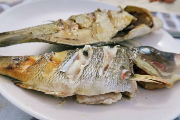 istock Open fire outdoor fish cooking on a sandy beach 966893432