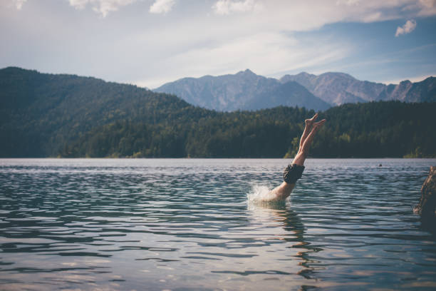Diving into Bavaria Lake Eibsee, Germany diving into water stock pictures, royalty-free photos & images