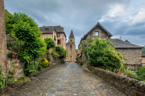 Conques, Midi Pyrenees, France - June 12, 2015: View of the medieval village of Conques and the Abbey Church of Saint Foy