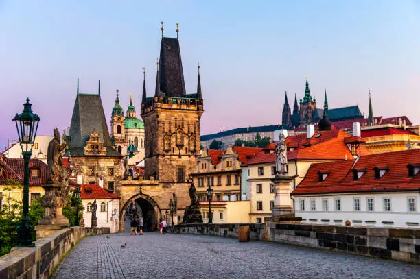 Photo of charles bridge (Karlův most) castle of Prague and St Vitus cathedral at sunrise. Czech Republic