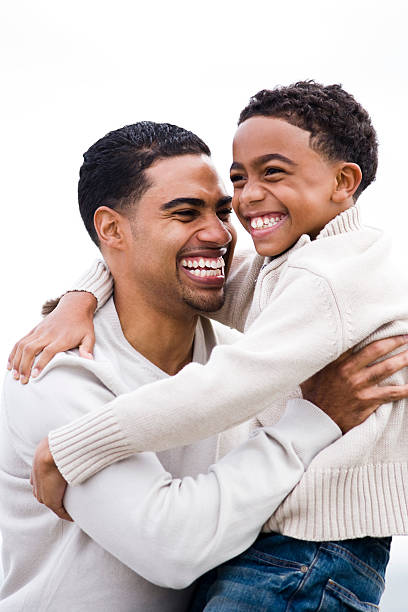istock Happy African-American dad hugging smiling son 96690796