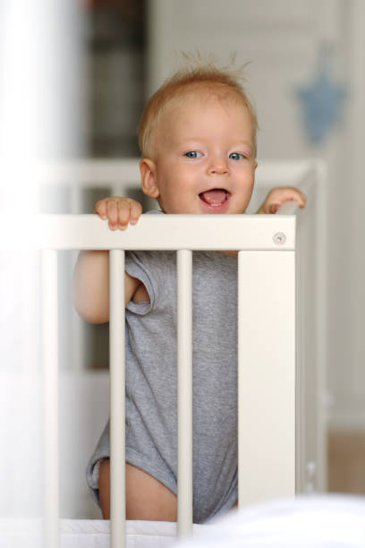 istock Baby boy standing in crib 966921968