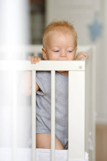 istock Baby boy standing in crib 966921988