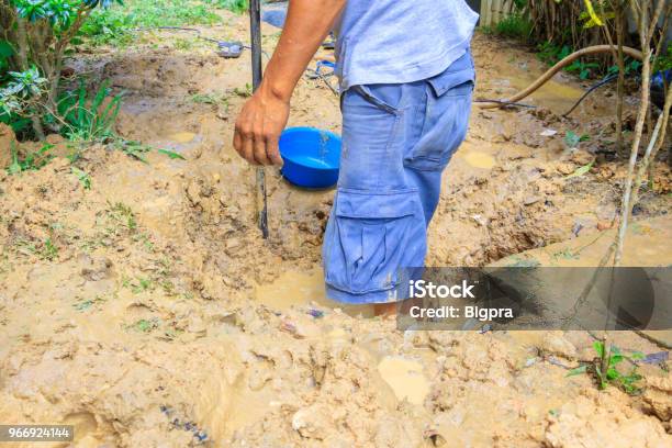 Male Plumber Are Repair Broken Pipe In Hole With Plumbing Water Flow Outdoor And Sunlight With Copy Space Add Text Stock Photo - Download Image Now