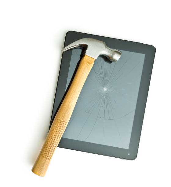 Tablet screen broken with a hammer. Tablet screen broken with a hammer. Isolated on white background. broken digital tablet note pad cracked stock pictures, royalty-free photos & images