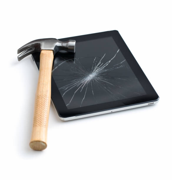 Tablet screen broken with a hammer. Tablet screen broken with a hammer. Isolated on white background. broken digital tablet note pad cracked stock pictures, royalty-free photos & images