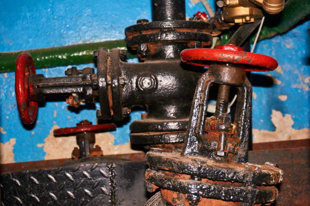 istock A few old painted black with red valves on the cold water pipeline. 966924918