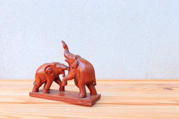 istock two wooden elephant conflict on wood floor table background with copy space add text 966926712