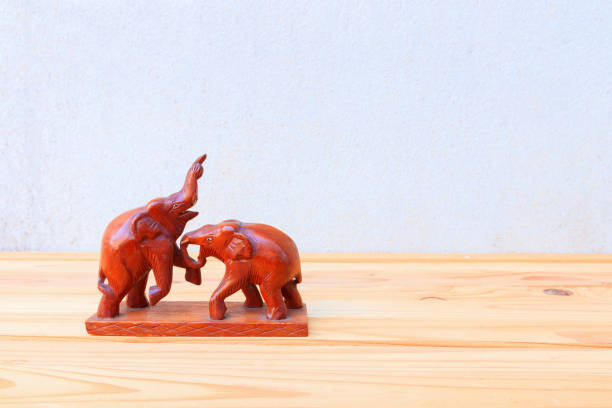 istock two wooden elephant conflict on wood floor table background with copy space add text 966926752