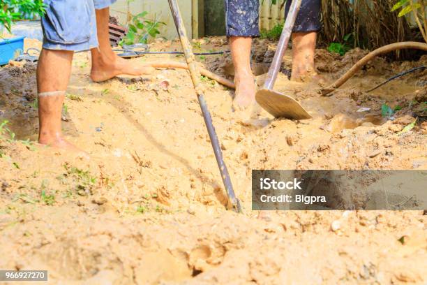 Male Plumber Are Repair Broken Pipe In Hole With Plumbing Water Flow Outdoor And Sunlight With Copy Space Add Text Stock Photo - Download Image Now