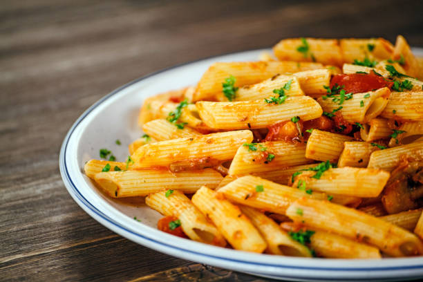 istock Penne with sauce and pork 966928756