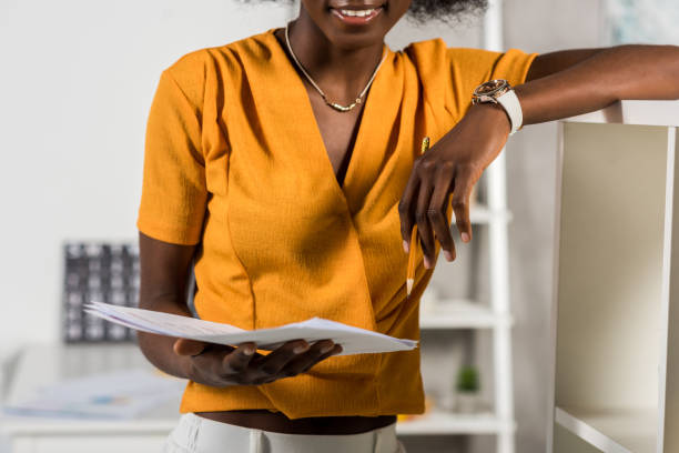 istock partial view of african american freelancer with papers at home office 966932126