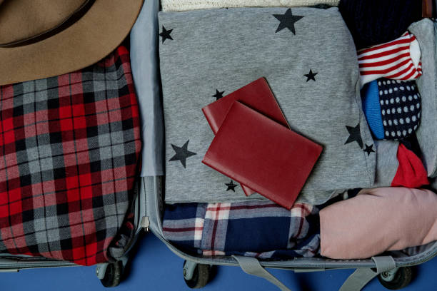 istock Open suitcase packed for travelling. Winter vacations and holidays. Top view 966933426