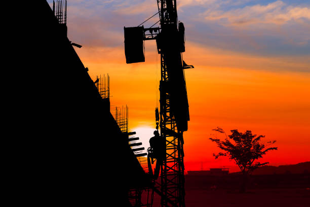 istock Silhouette Tower crane construction work on sunset-sunrise time background and copy space add text 966934454