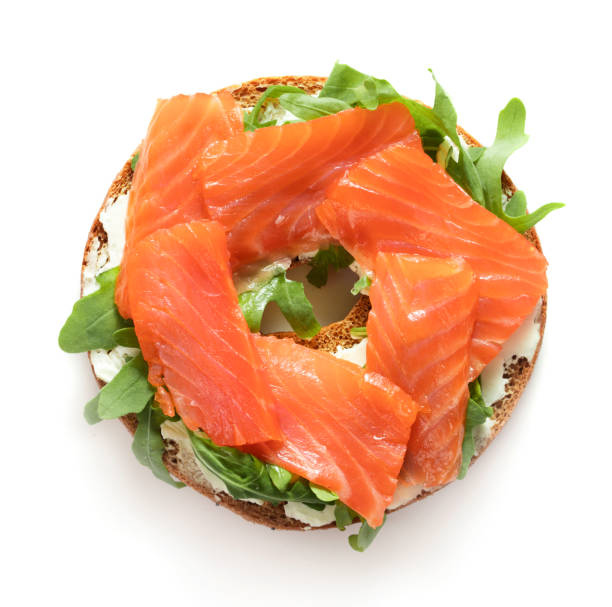 bagel sandwich with salmon top view of bagel sandwich with salmon isolated on white background smoked salmon stock pictures, royalty-free photos & images