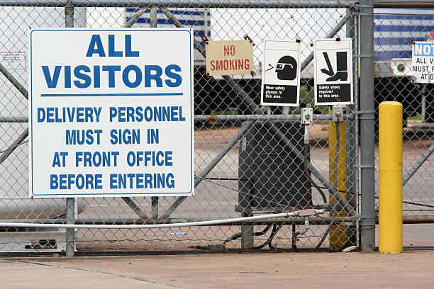 Industrial plant entrance Signage at the entrance to an industrial plant. PLEASE EMAIL ME to let me know how you used my photograph. I would appreciate it very much!! THANKS. security barrier photos stock pictures, royalty-free photos & images