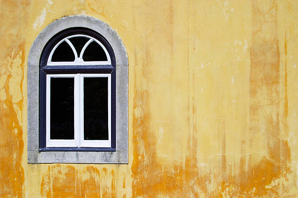 istock Traditional window on yellow background wall in the sun 96695189