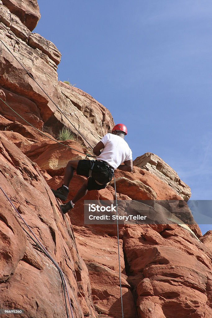 Мужской альпинист порядке убывания скале - Стоковые фото Верёвка роялти-фри