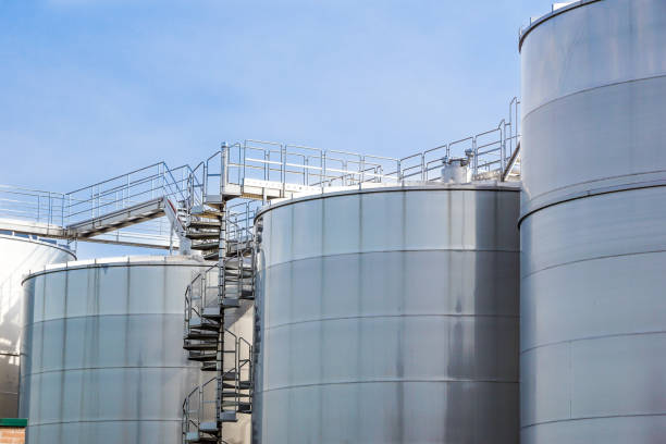 View of the cylindrical, vertical crude oil and chemical storage tank in the plant.