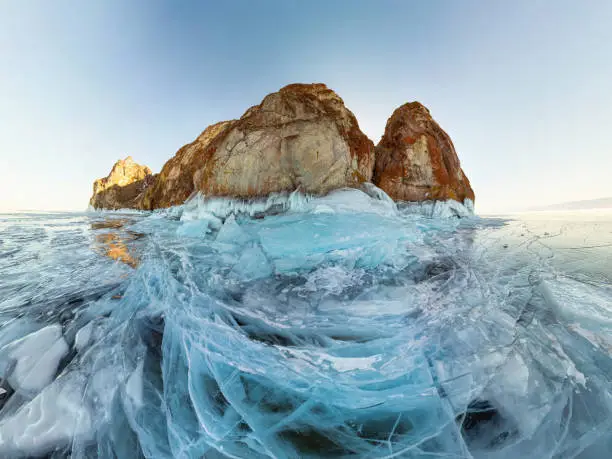rock in the ice of Lake Baikal, the island of Olkhon. Panorama landscape, abstraction.
