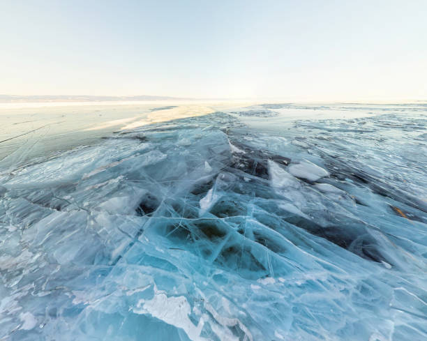 istock Background ice blue crystal clear lake covered with cracks 966953420