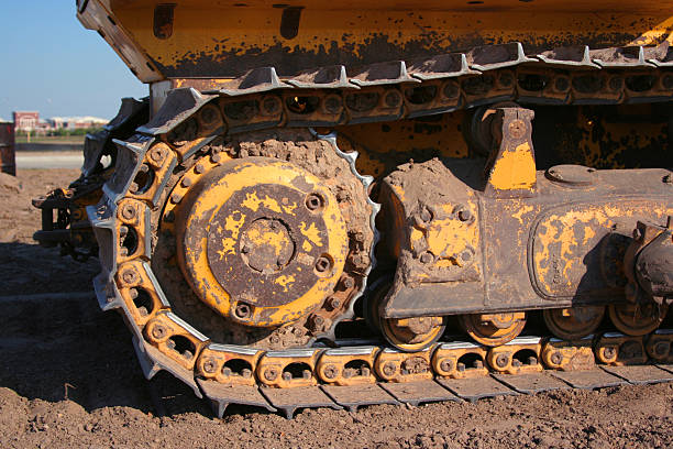 Bulldozer treads creap along stock photo