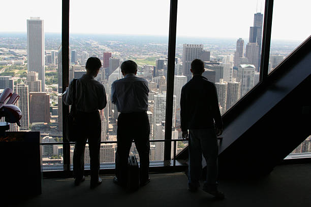 Tourists view Chicago from John Hancock Tower Observatory stock photo