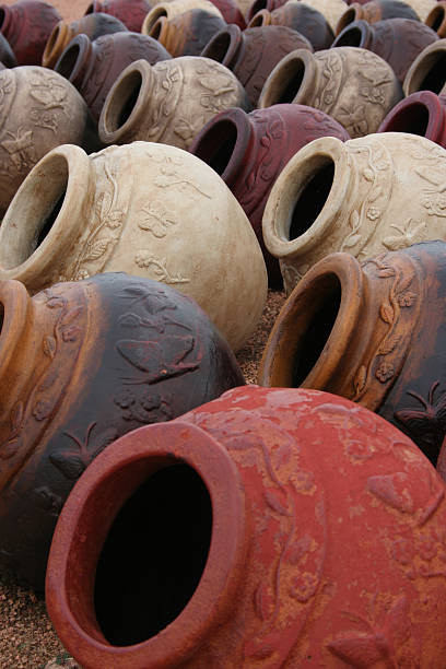 Rows of clay pottery displayed and for sale at nursery stock photo