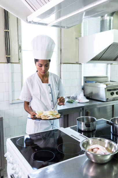 istock Female chef preparing food in asian restaurant 966960480